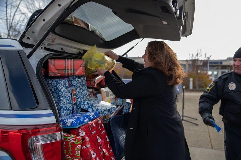 Woman places gifts in car