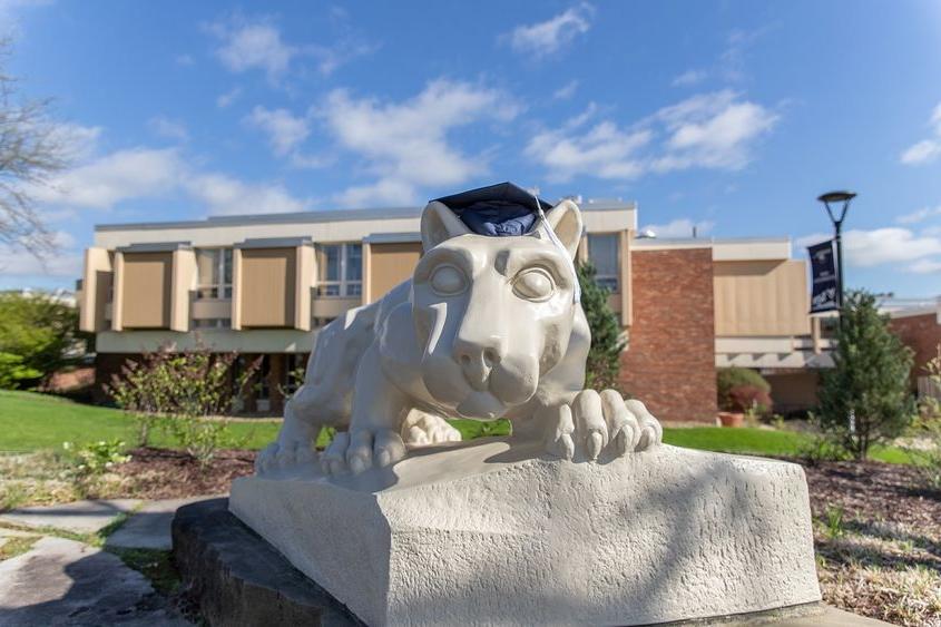 Lion shrine statue with graduation mortarboard